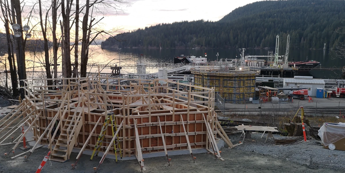 construction site for a new terminal on an inlet. structures in mid construction visible.