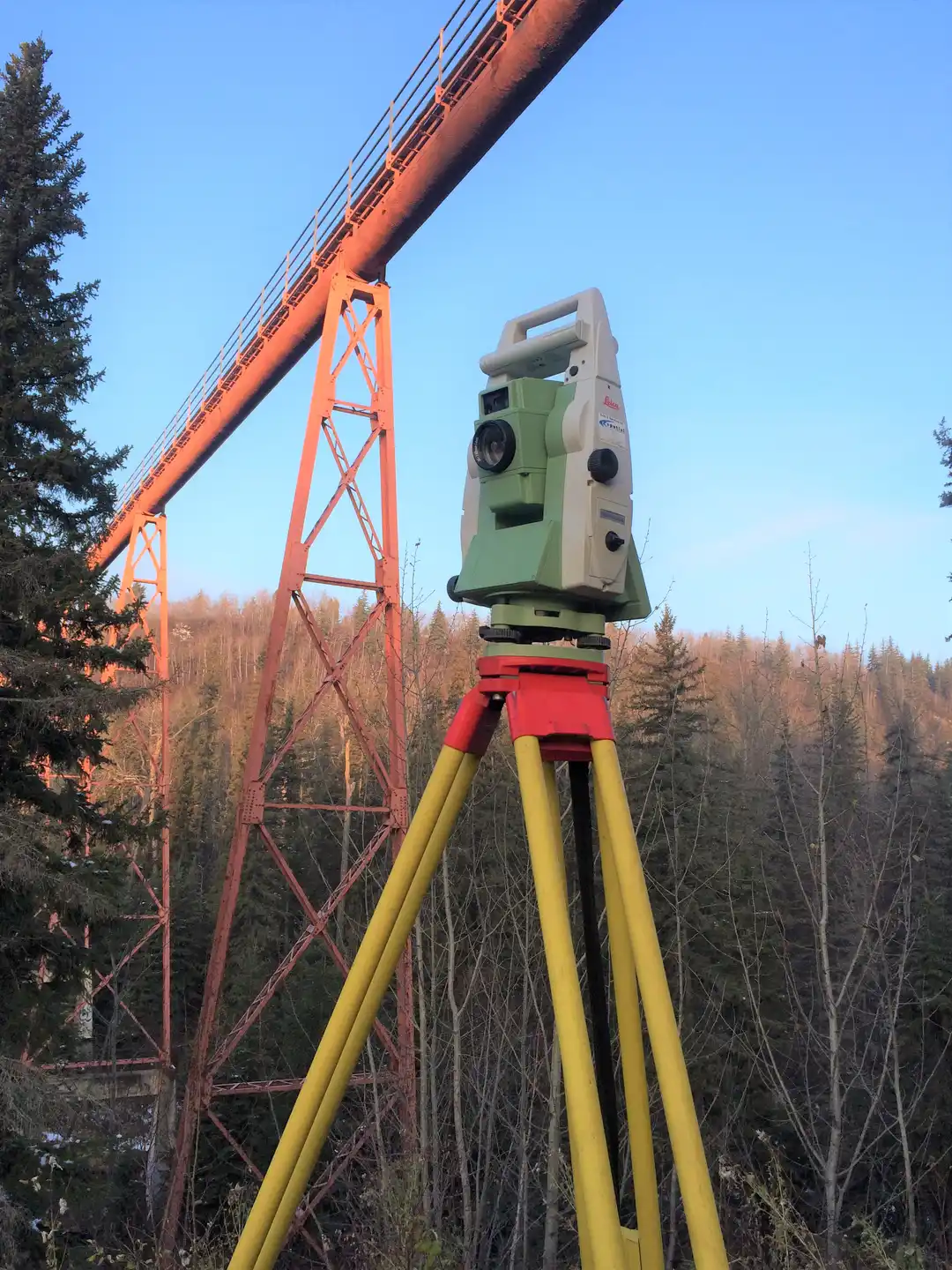 artistic shot of survey equipment under bridge on a sunny day